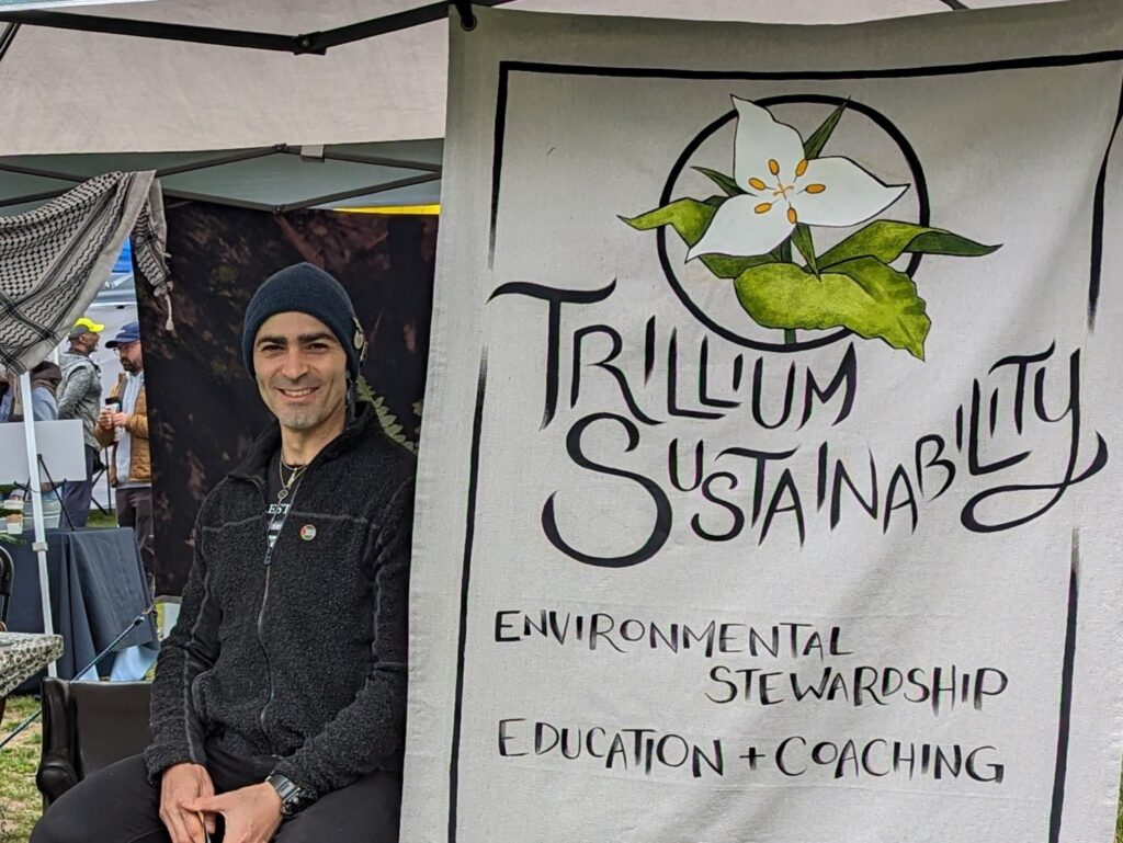 Tareq Fayyad, Sustainability Coach and Educator, next to a banner with the Trillium Sustainability logo, featuring a Trillium flower.